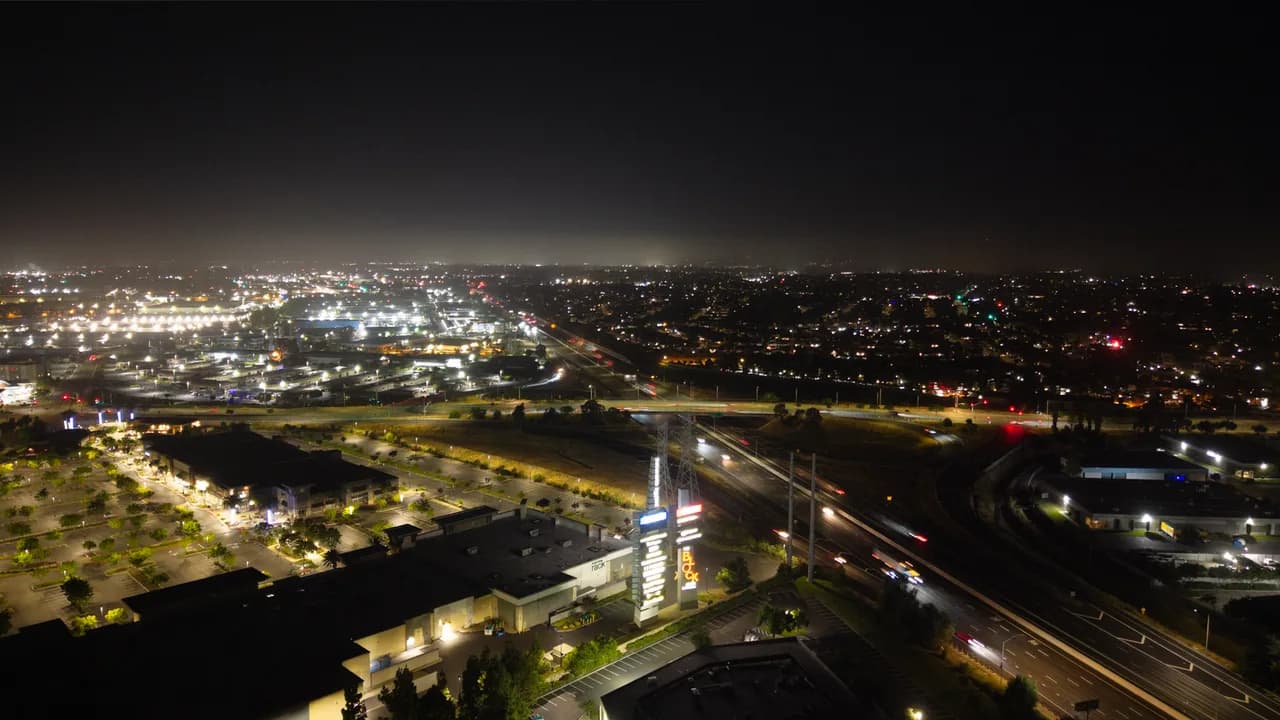 Rail lines and curving roads cross beneath distant city lights. After Dark photo 6 of 9.